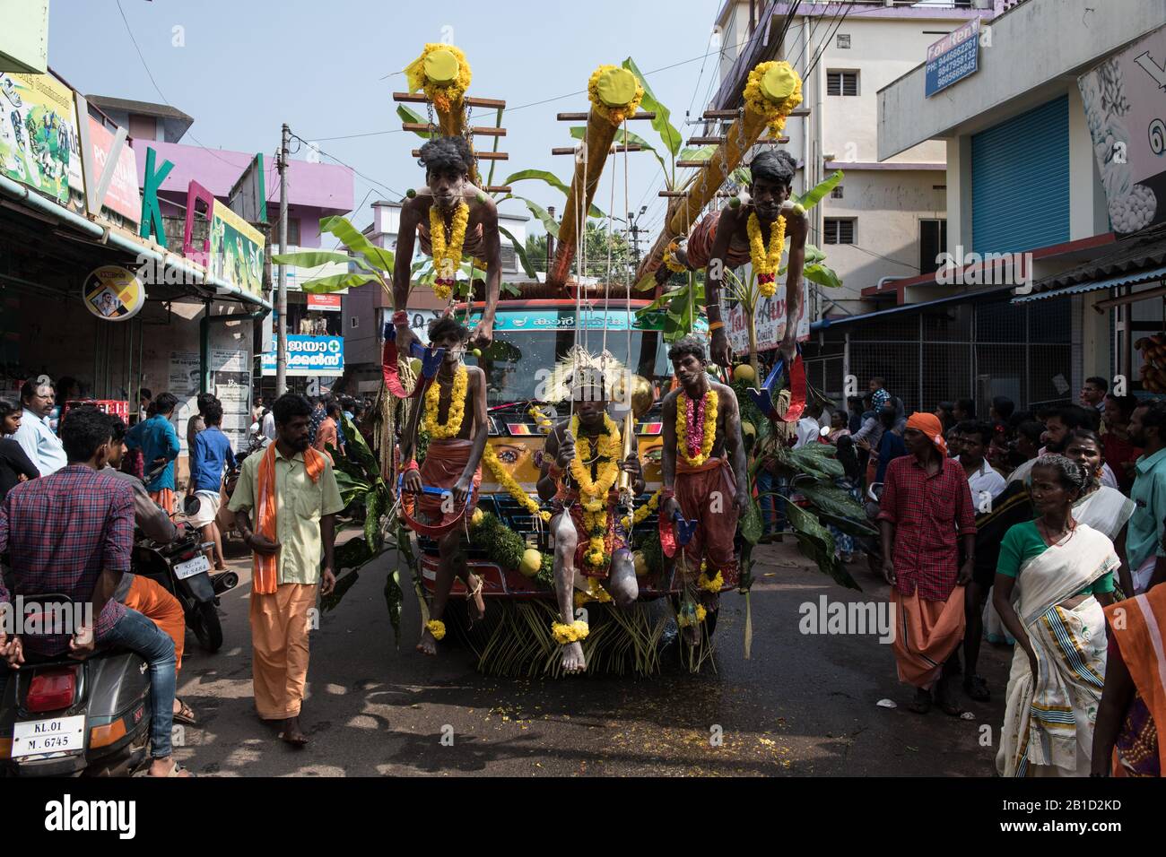 Devotees hanging by hooks piercing their skin as a ritualistic act of