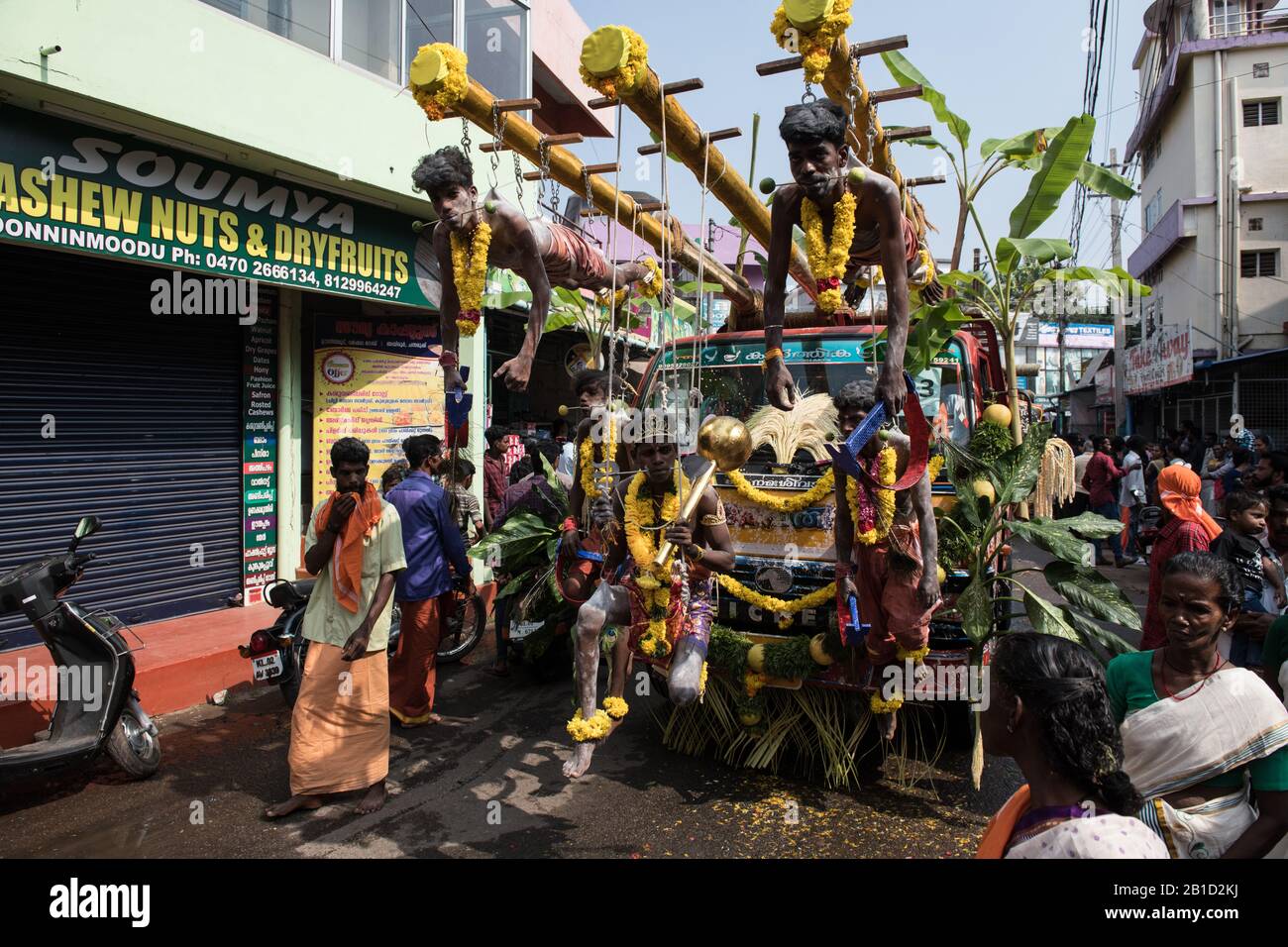 Devotees hanging by hooks piercing their skin as a ritualistic act of devotion, Garudan Thookkam (Eagle Hanging), during Thaipooyam, or Thaipoosam, Fe Stock Photo