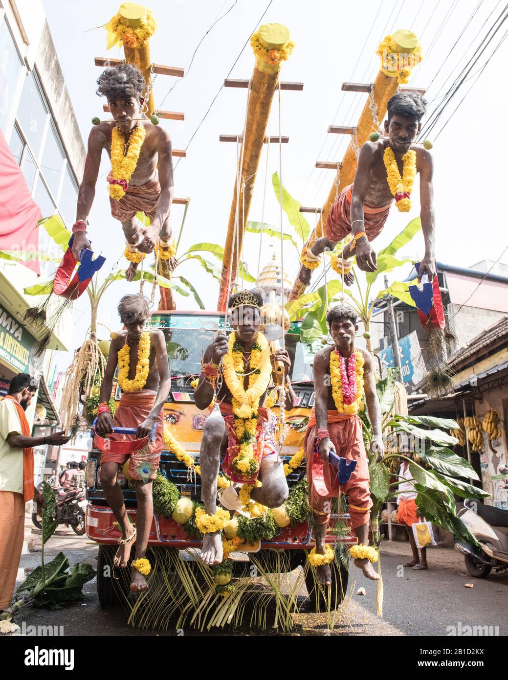 Devotees hanging by hooks piercing their skin as a ritualistic act of devotion, Garudan Thookkam (Eagle Hanging), during Thaipooyam, or Thaipoosam, Fe Stock Photo