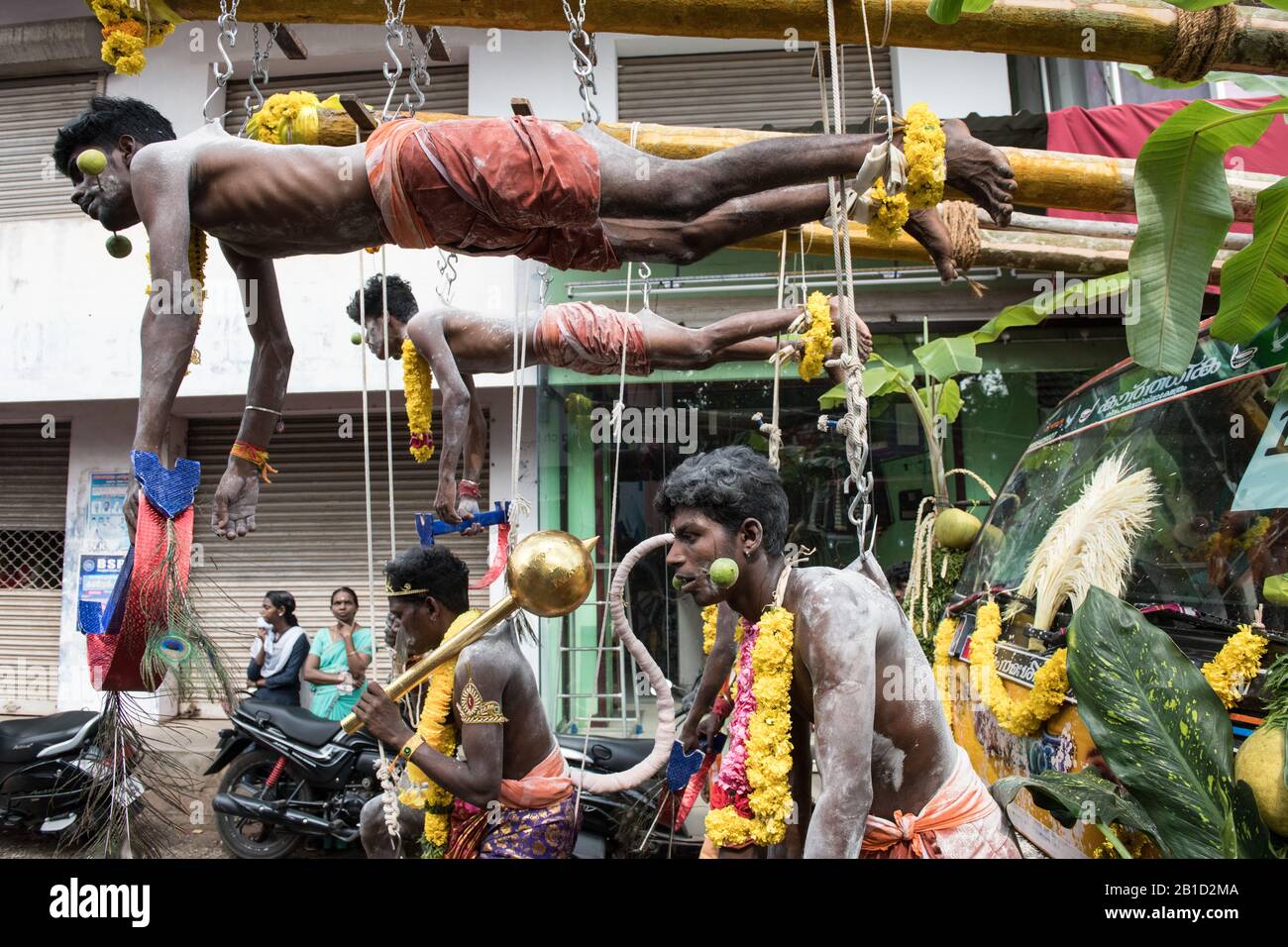 Devotees hanging by hooks piercing their skin as a ritualistic act of devotion, Garudan Thookkam (Eagle Hanging), during Thaipooyam, or Thaipoosam, Fe Stock Photo