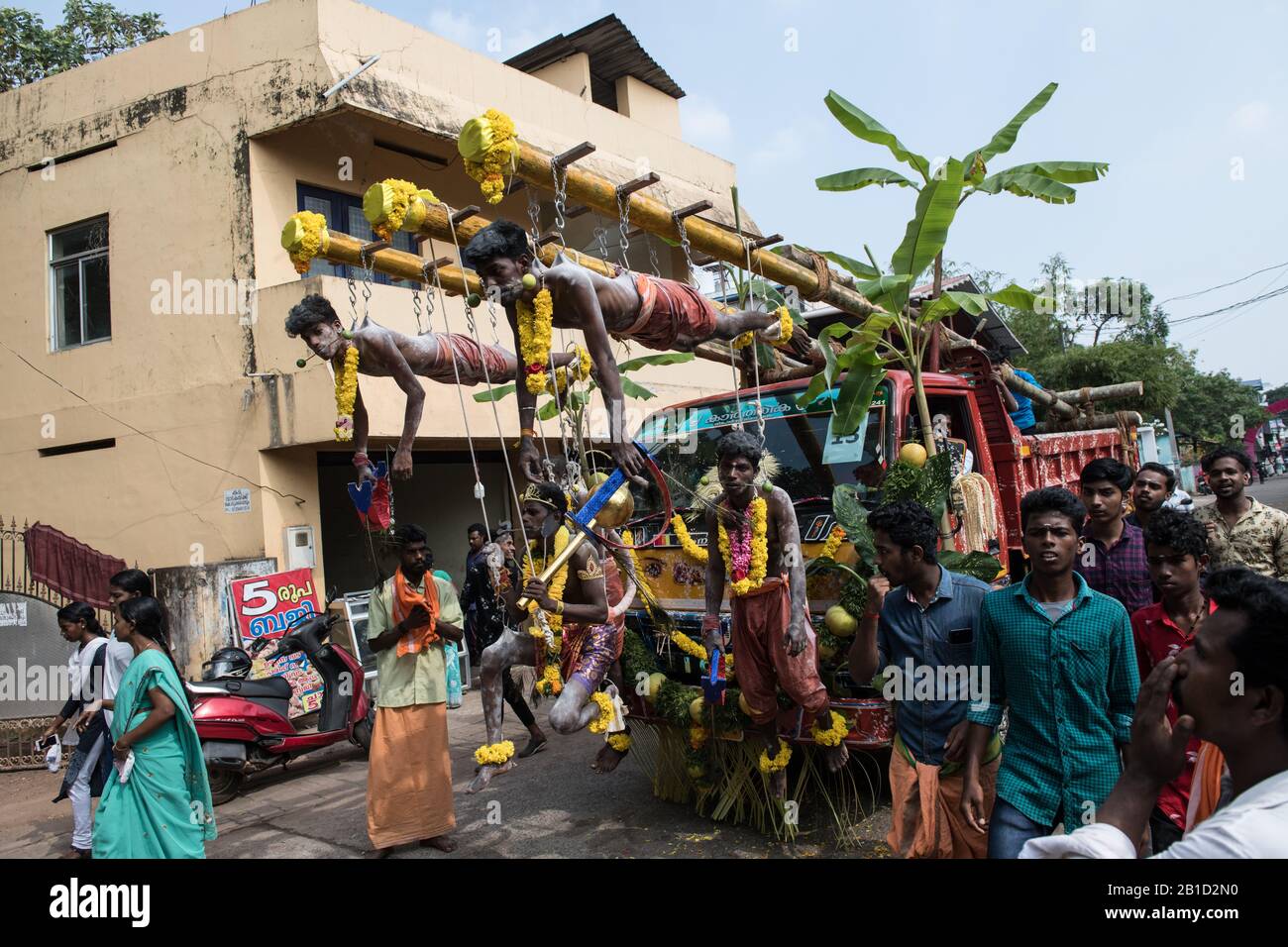 Devotees hanging by hooks piercing their skin as a ritualistic act of devotion, Garudan Thookkam (Eagle Hanging), during Thaipooyam, or Thaipoosam, Fe Stock Photo