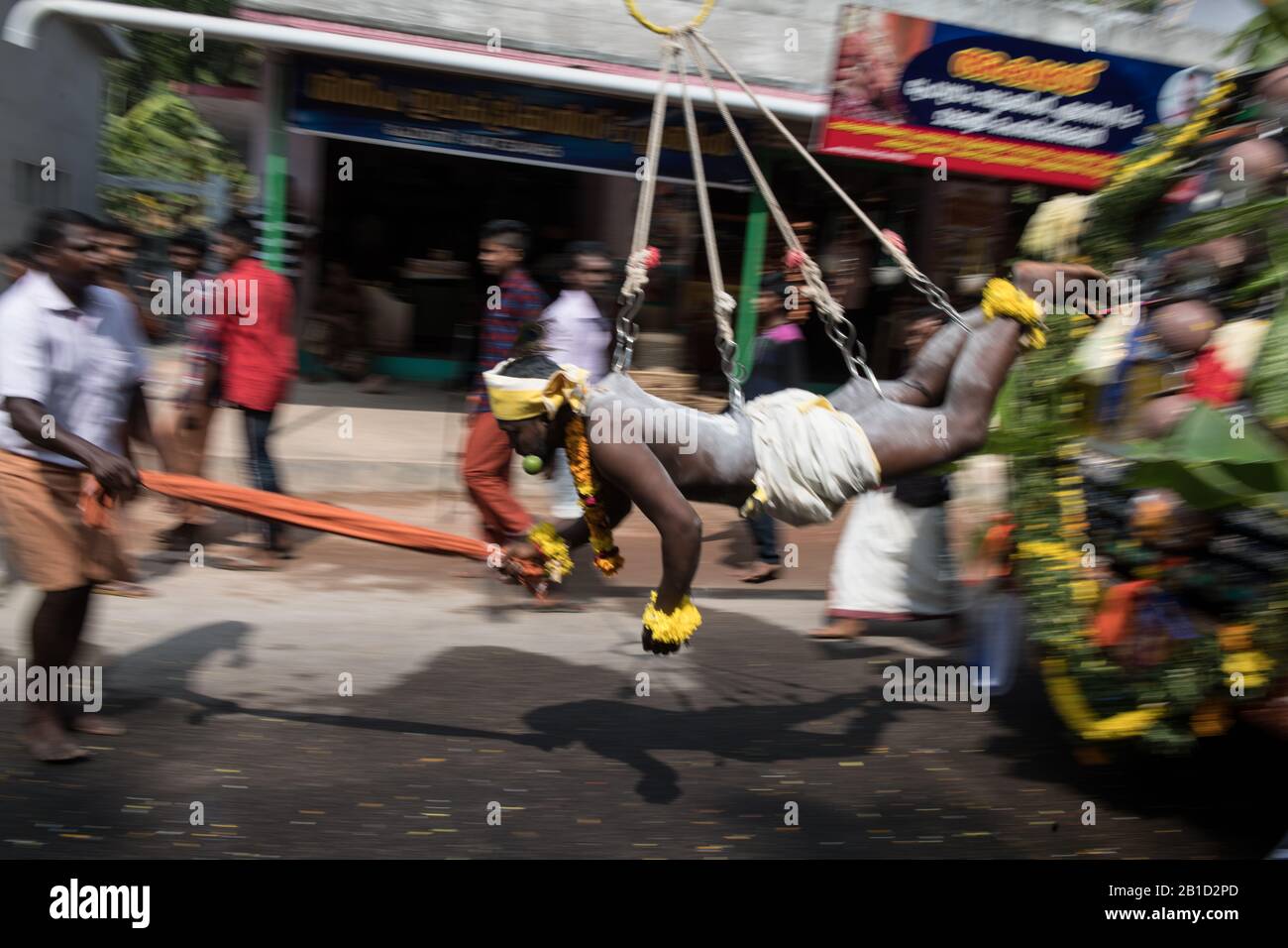 Devotee hanging by hook piercings as a ritualistic act of devotion