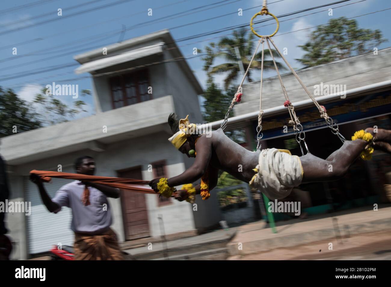Devotee hanging by hook piercings as a ritualistic act of devotion