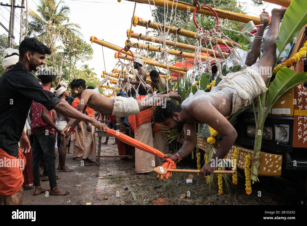 Devotees hanging by hooks piercing their skin as a ritualistic act of devotion, Garudan Thookkam (Eagle Hanging), during Thaipooyam, or Thaipoosam, Fe Stock Photo