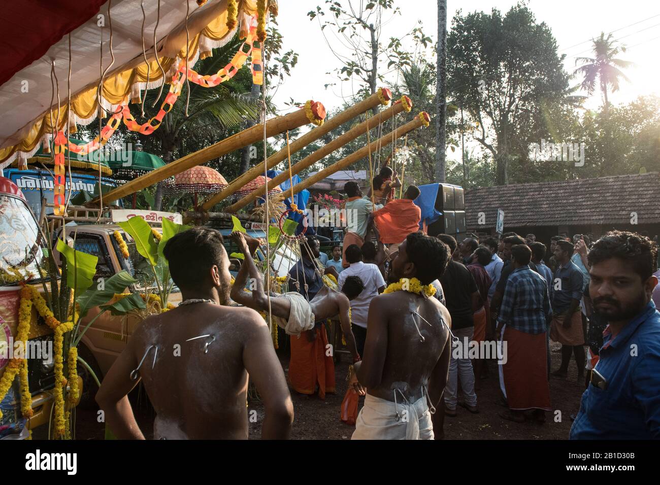 Devotees hanging by hooks piercing their skin as a ritualistic act of