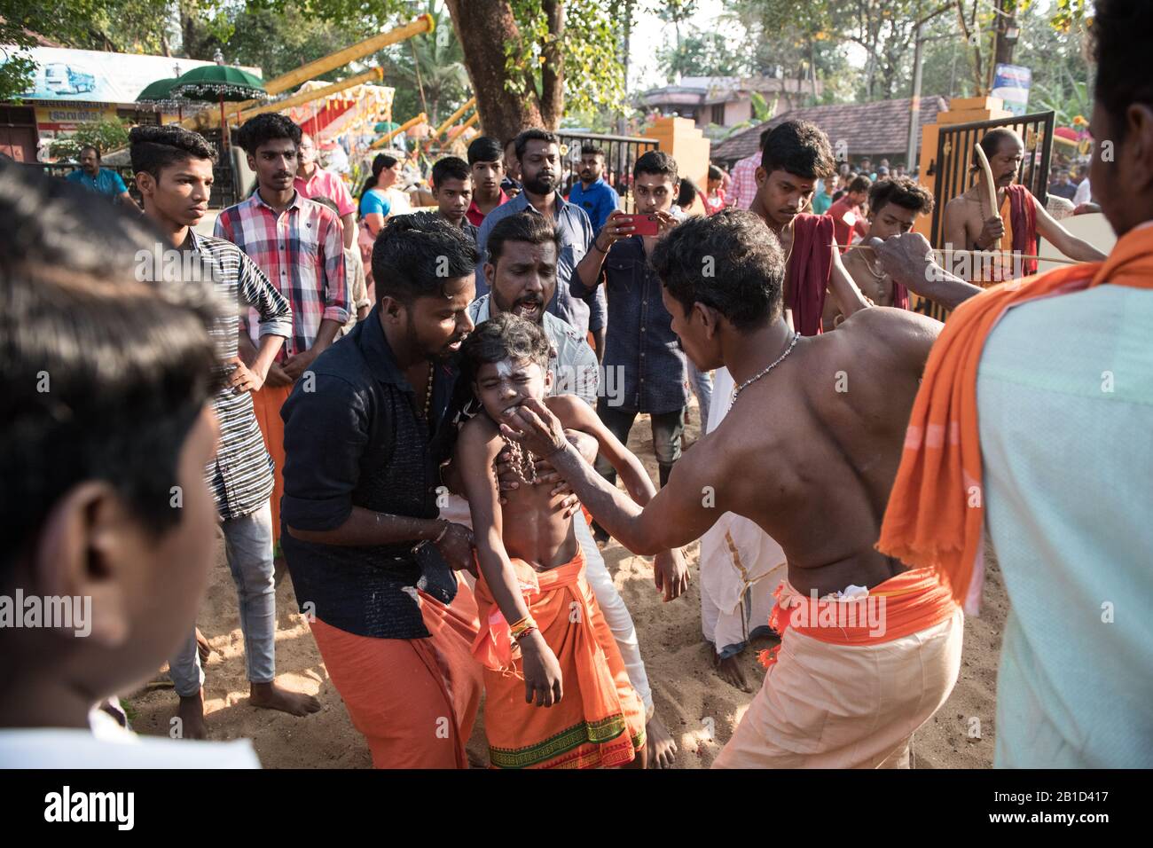 Devotees having a spear piercing in his mouth (Kavadi Aattam) as an act of devotion during Thaipooyam, or Thaipoosam, Festival in Kedakulam, Kerala. Stock Photo