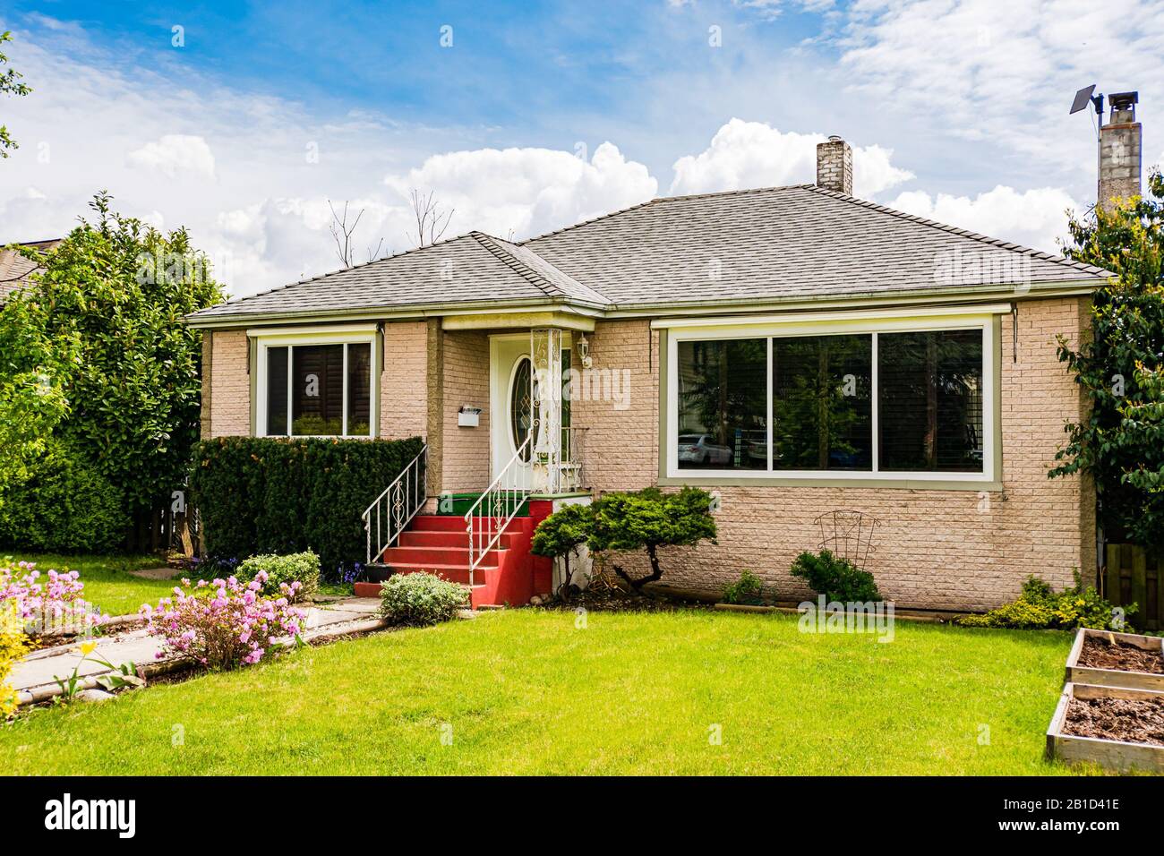 Modest family house with green lawn in front Stock Photo Alamy