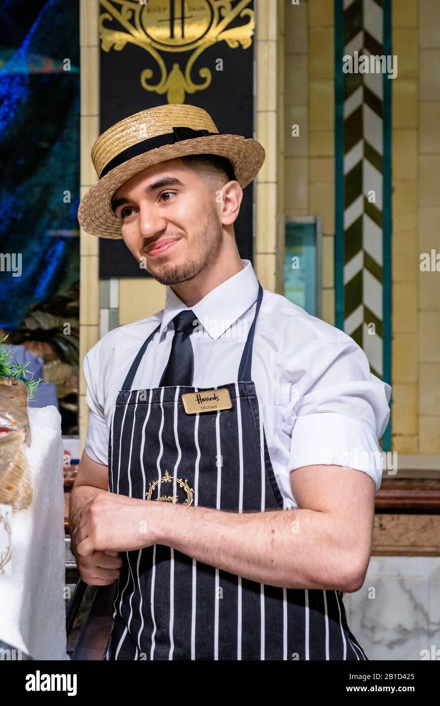 Harrods Food Hall employee at work with a smile on his face. Stock Photo