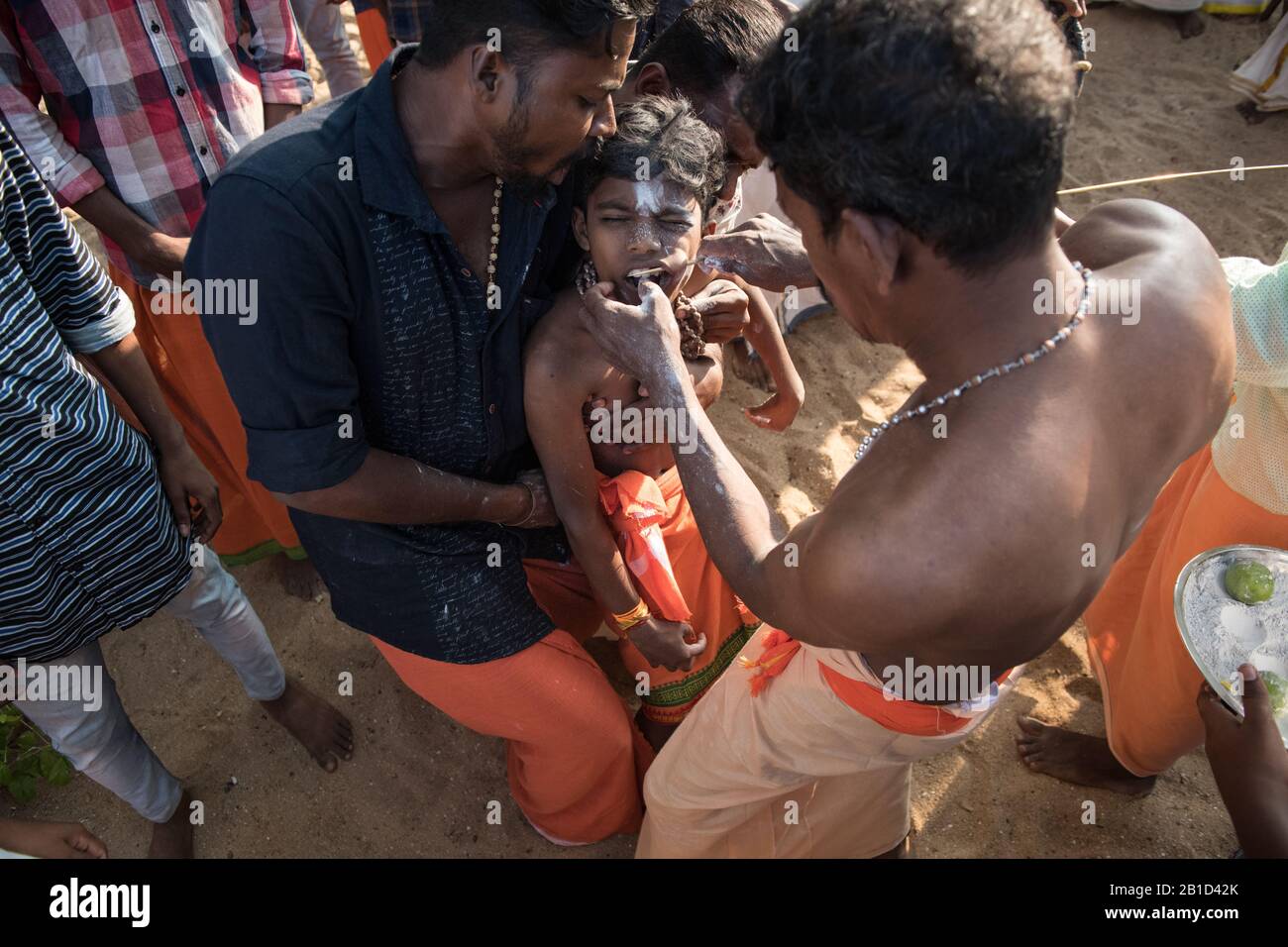 Devotees having a spear piercing in his mouth (Kavadi Aattam) as an act of devotion during Thaipooyam, or Thaipoosam, Festival in Kedakulam, Kerala. Stock Photo