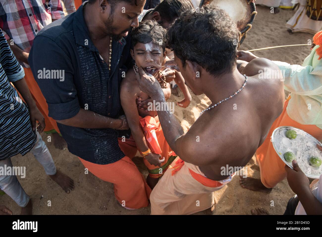 Devotees having a spear piercing in his mouth (Kavadi Aattam) as an act of devotion during Thaipooyam, or Thaipoosam, Festival in Kedakulam, Kerala. Stock Photo