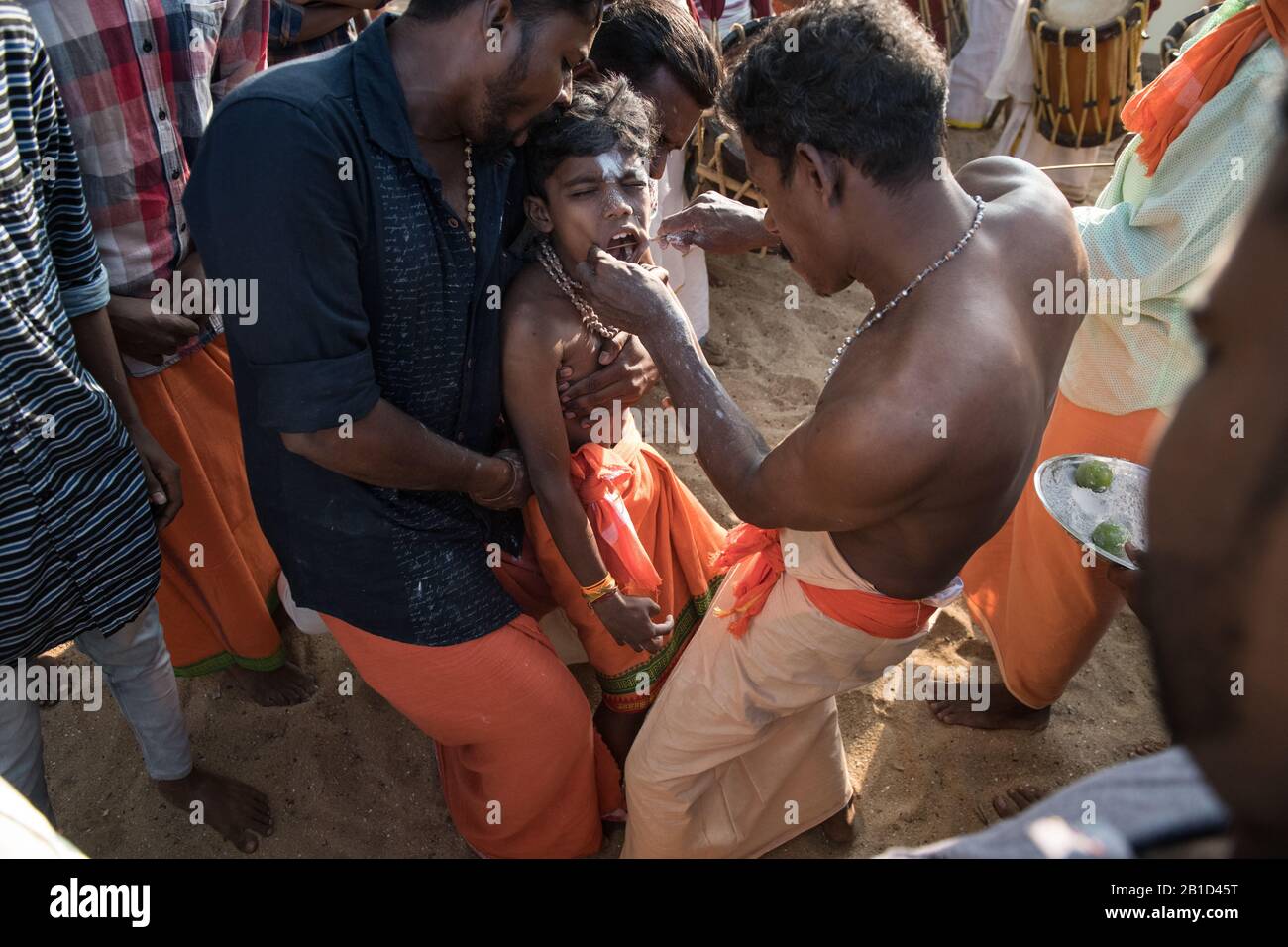 Devotees having a spear piercing in his mouth (Kavadi Aattam) as an act of devotion during Thaipooyam, or Thaipoosam, Festival in Kedakulam, Kerala. Stock Photo