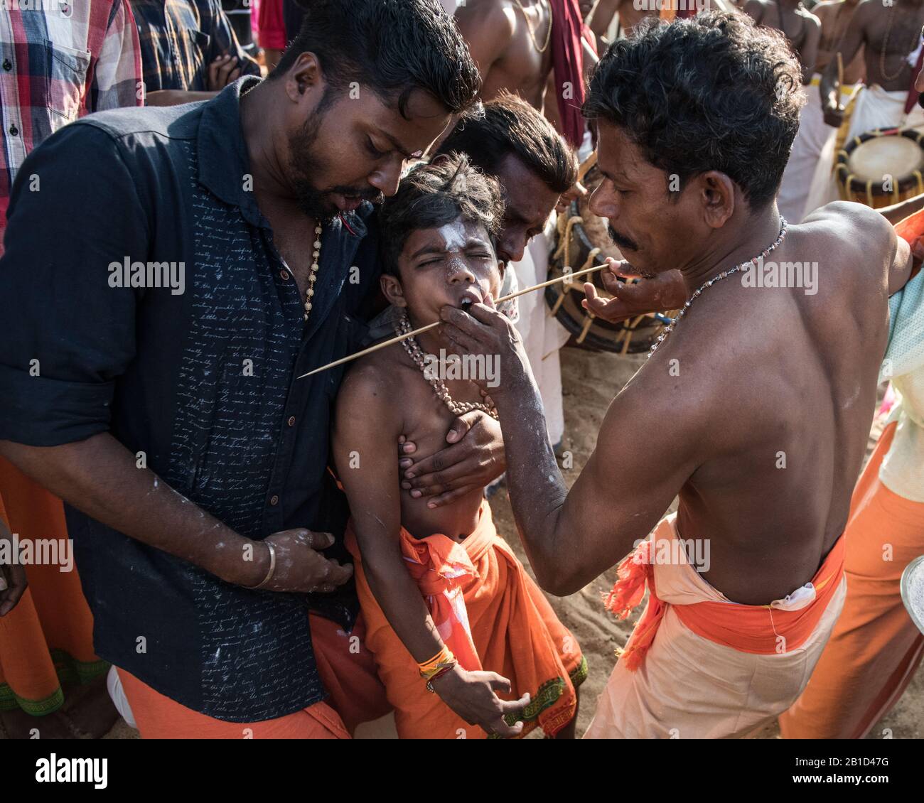 Devotees having a spear piercing in his mouth (Kavadi Aattam) as an act of devotion during Thaipooyam, or Thaipoosam, Festival in Kedakulam, Kerala. Stock Photo