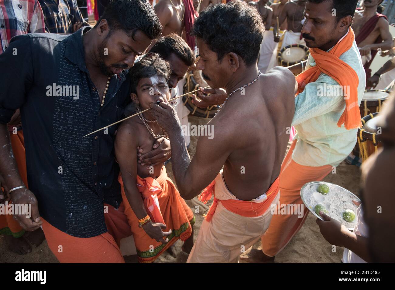 Devotees having a spear piercing in his mouth (Kavadi Aattam) as an act of devotion during Thaipooyam, or Thaipoosam, Festival in Kedakulam, Kerala. Stock Photo