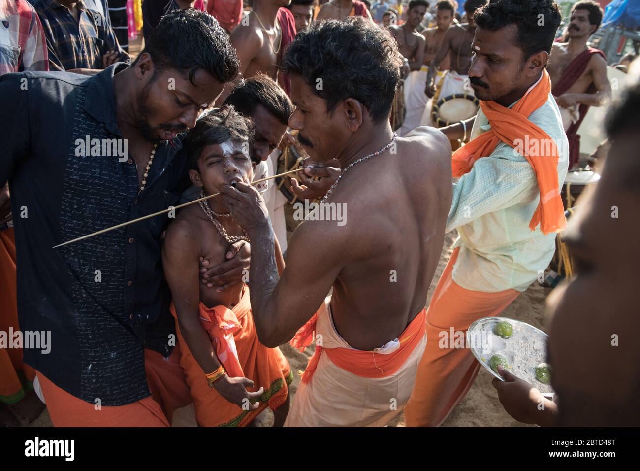 Devotees having a spear piercing in his mouth (Kavadi Aattam) as an act of devotion during Thaipooyam, or Thaipoosam, Festival in Kedakulam, Kerala. Stock Photo