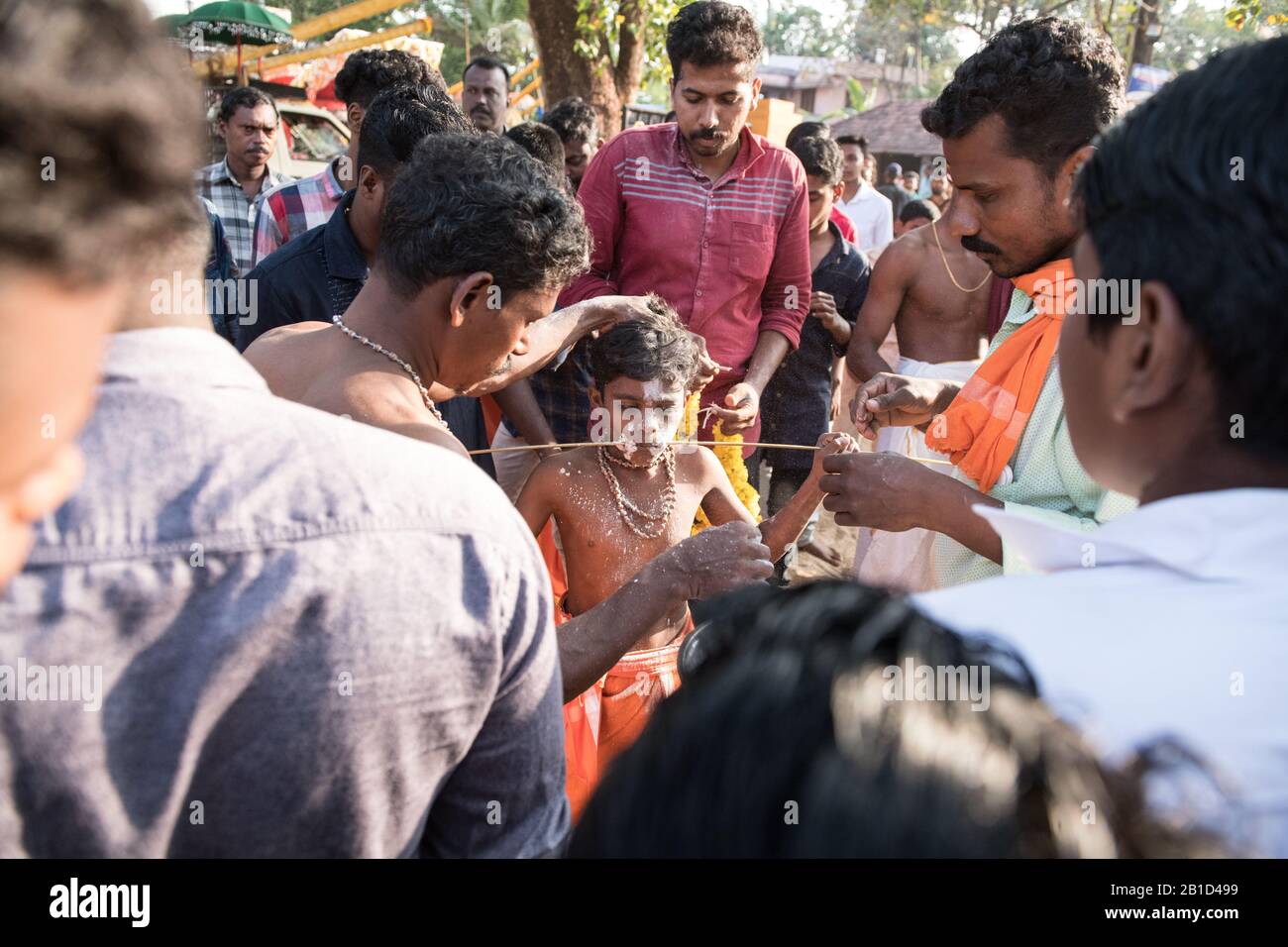 Devotees holding spears in their pierced mouths (Kavadi Aattam) as an act of devotion during Thaipooyam, or Thaipoosam, Festival in Kedakulam, Kerala. Stock Photo