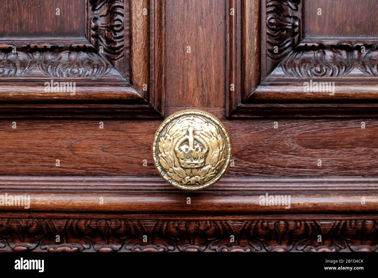 Golden polished door knob with British royal crown symbol engraved Stock Photo