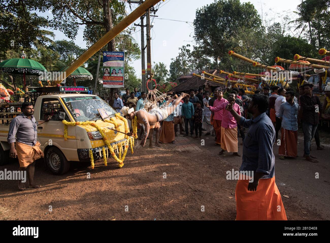 Devotees hanging by hooks piercing their skin as a ritualistic act of devotion, Garudan Thookkam (Eagle Hanging), during Thaipooyam, or Thaipoosam, Fe Stock Photo