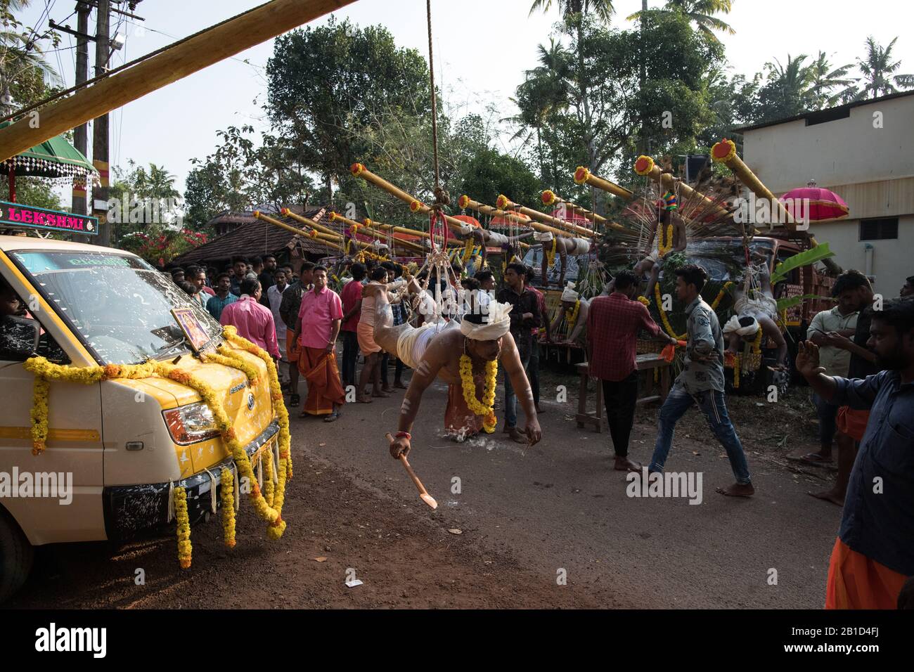 Devotees hanging by hooks piercing their skin as a ritualistic act of devotion, Garudan Thookkam (Eagle Hanging), during Thaipooyam, or Thaipoosam, Fe Stock Photo