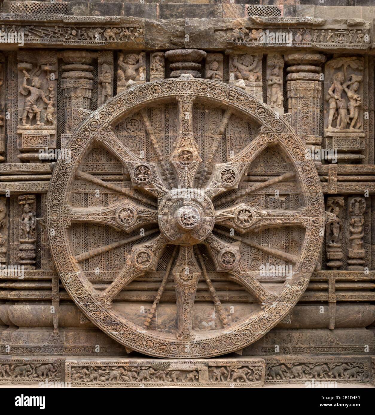 A stone wheel depicting time of a day Stock Photo