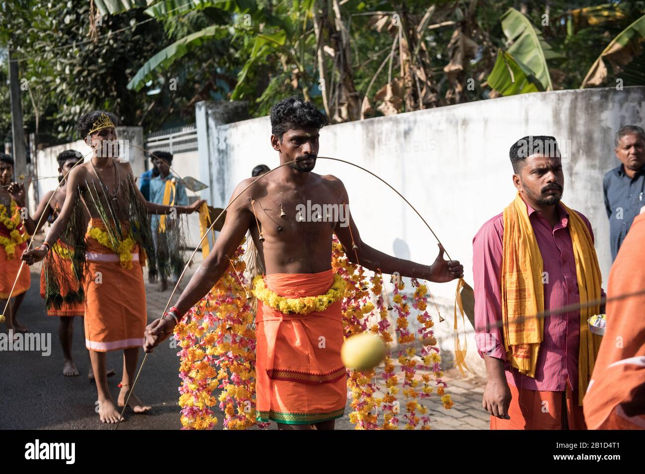 Devotees holding spears in their pierced mouths (Kavadi Aattam) as an act of devotion during Thaipooyam, or Thaipoosam, Festival in Kedakulam, Kerala. Stock Photo