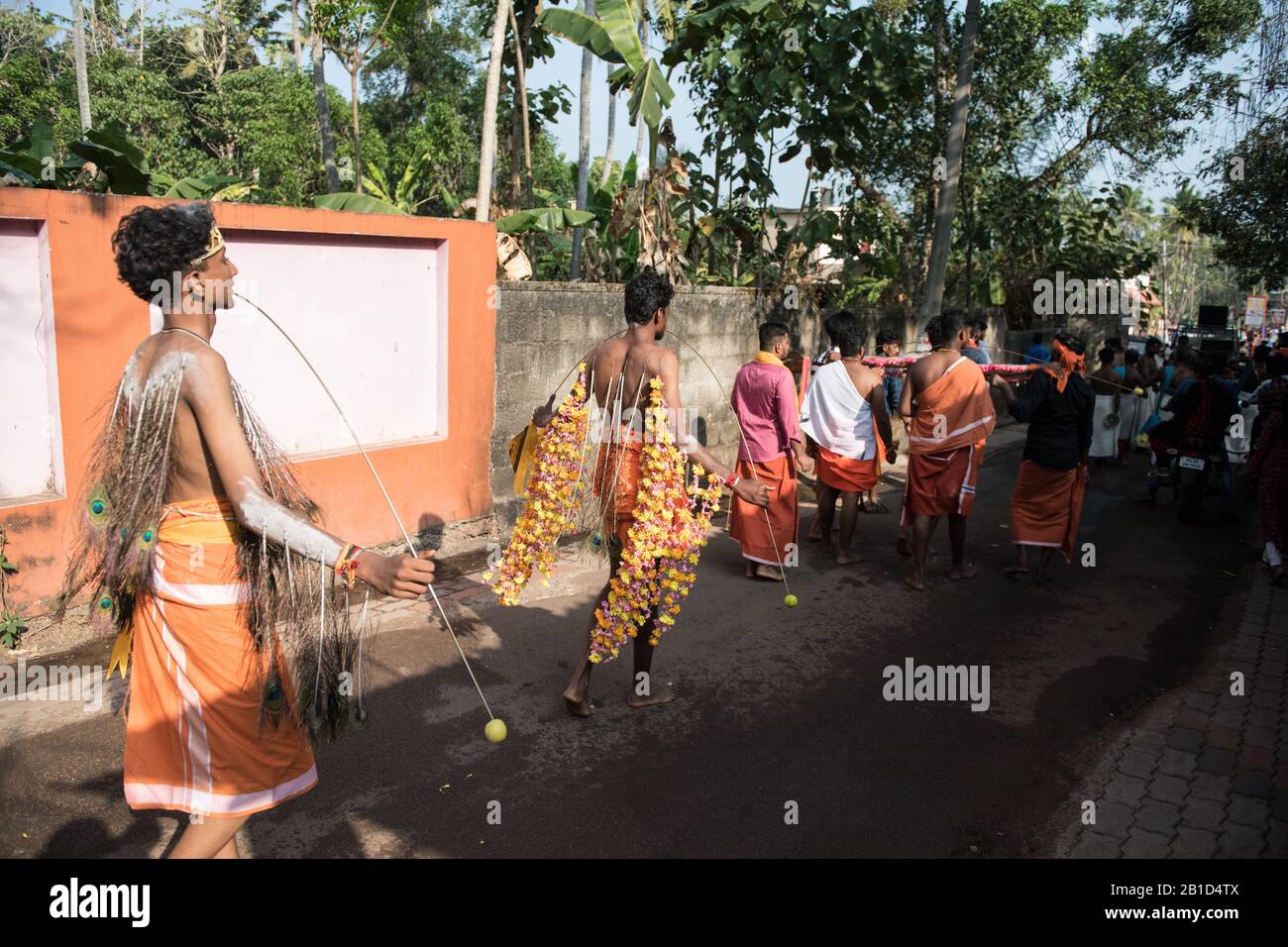 Devotees holding spears in their pierced mouths (Kavadi Aattam) as an act of devotion during Thaipooyam, or Thaipoosam, Festival in Kedakulam, Kerala. Stock Photo