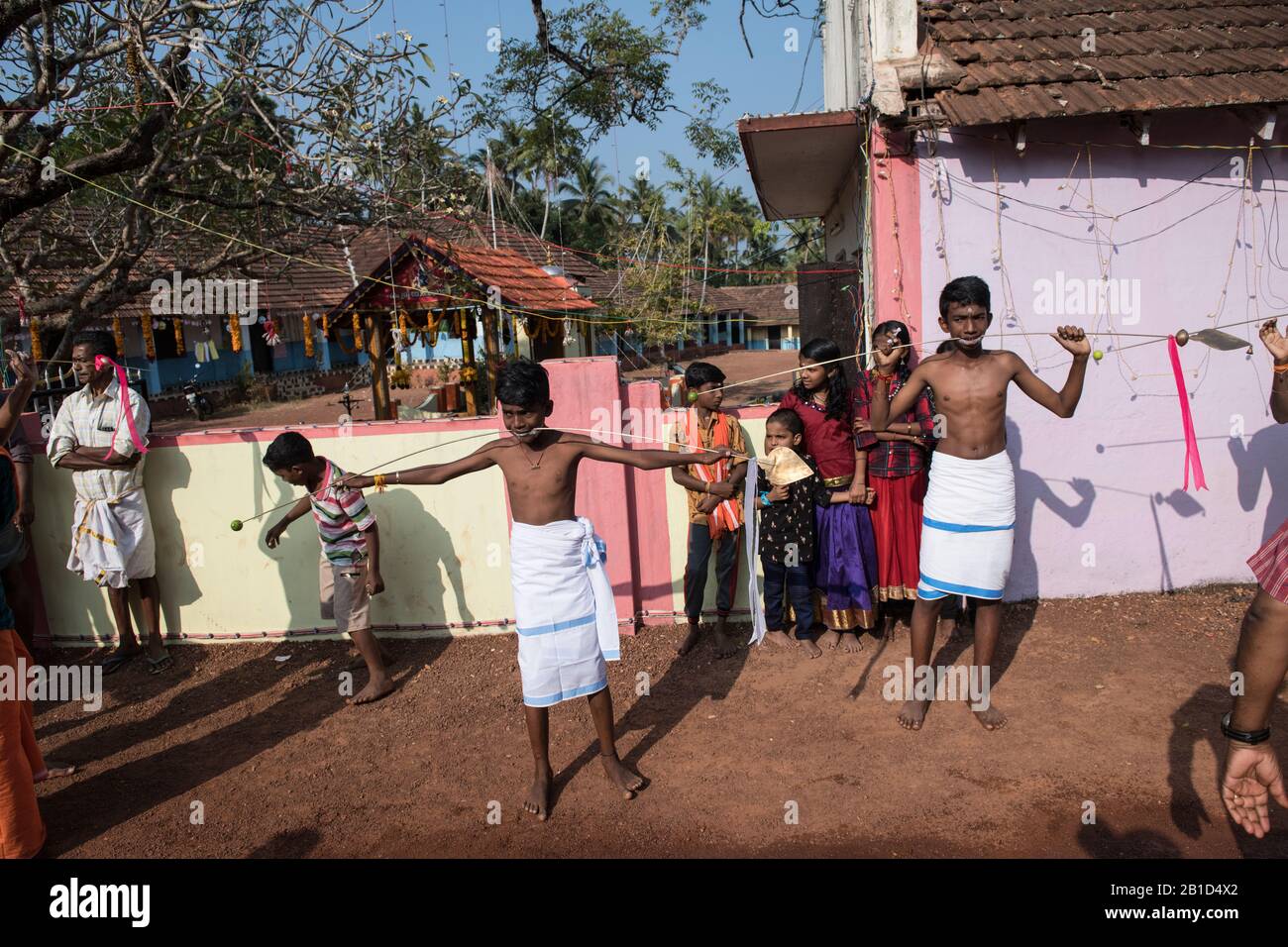 Devotees holding spears in their pierced mouths (Kavadi Aattam) as an act of devotion during Thaipooyam, or Thaipoosam, Festival in Kedakulam, Kerala. Stock Photo