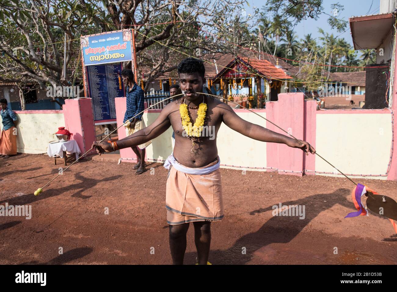 Devotee with spear-pierced mouths (Kavadi Aattam) as an act of devotion during Thaipooyam, or Thaipoosam, Festival in Kedakulam, Kerala. Stock Photo