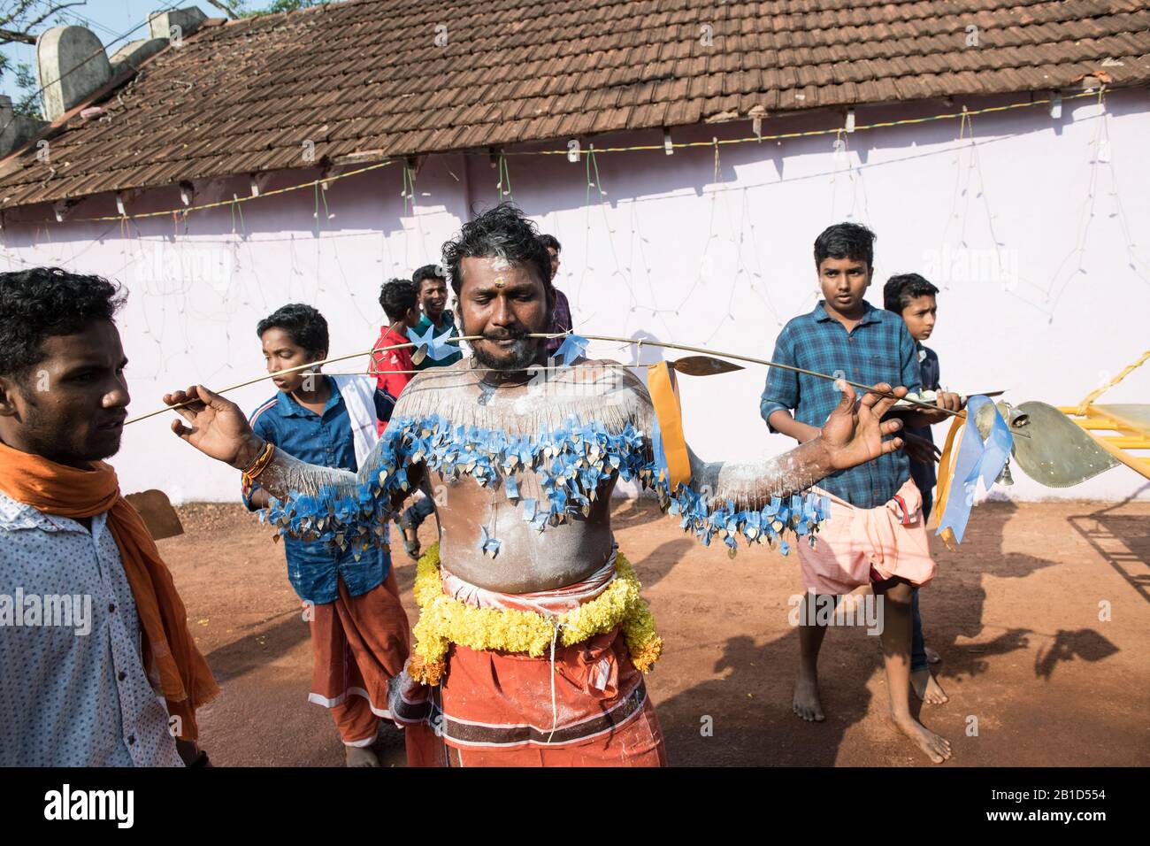 Devotees holding spears in their pierced mouths (Kavadi Aattam) as an act of devotion during Thaipooyam, or Thaipoosam, Festival in Kedakulam, Kerala. Stock Photo