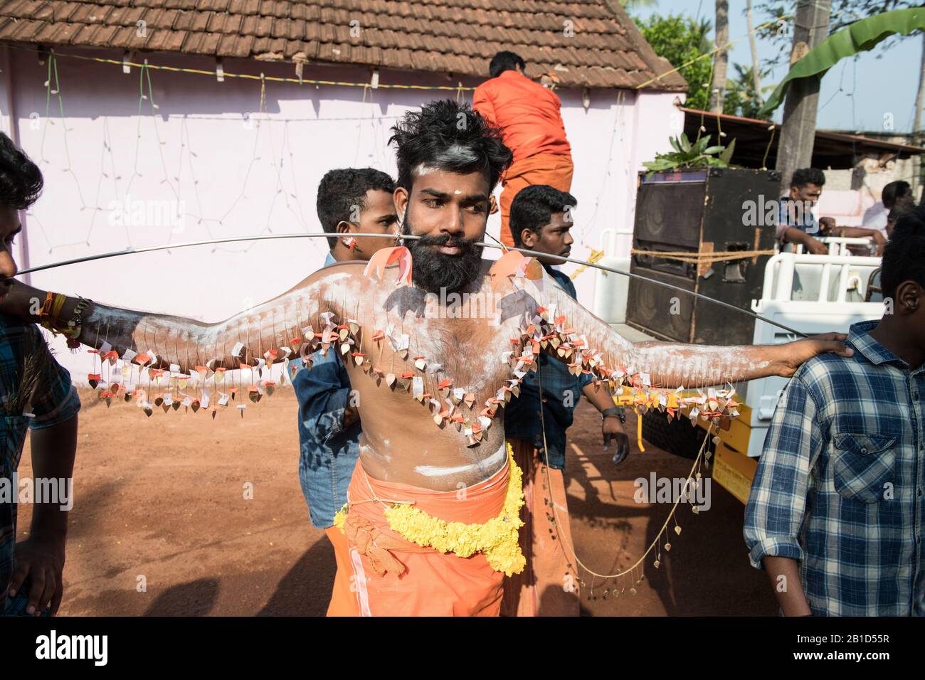 Devotees holding spears in their pierced mouths (Kavadi Aattam) as an act of devotion during Thaipooyam, or Thaipoosam, Festival in Kedakulam, Kerala. Stock Photo