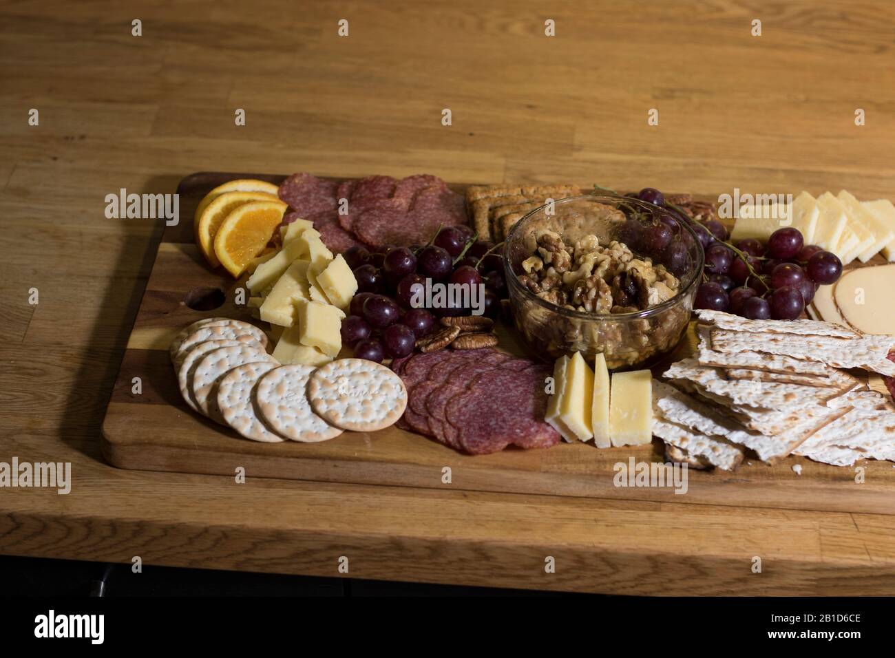 Eating crackers snack food from charcuterie board. Mediterranean cuisine of assorted lunch meats