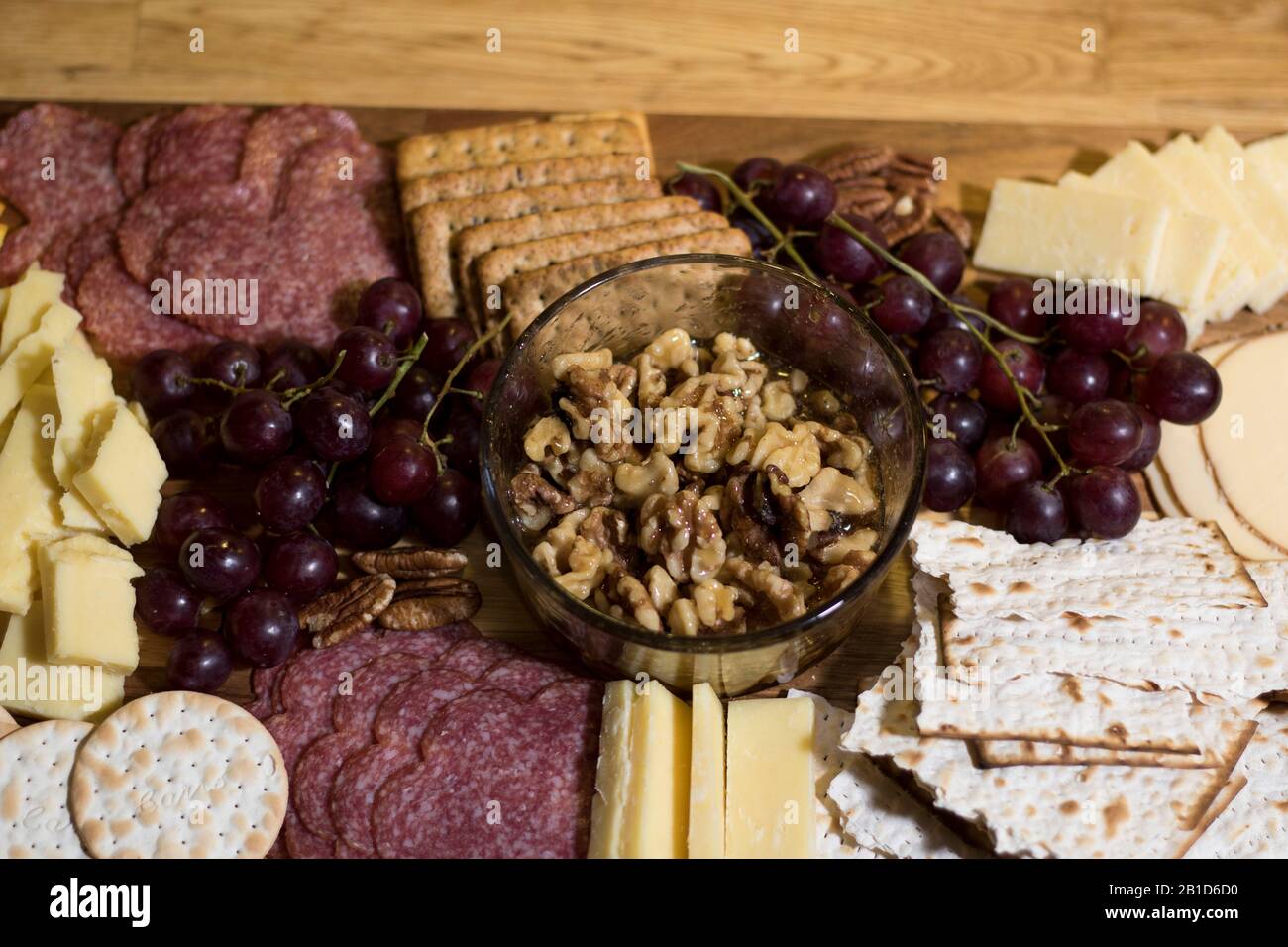 Eating food from charcuterie board. Fresh meats, cheeses, crackers