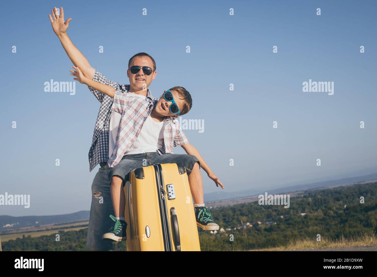 Father and son standing on the road at the day time. Concept of tourism. Stock Photo