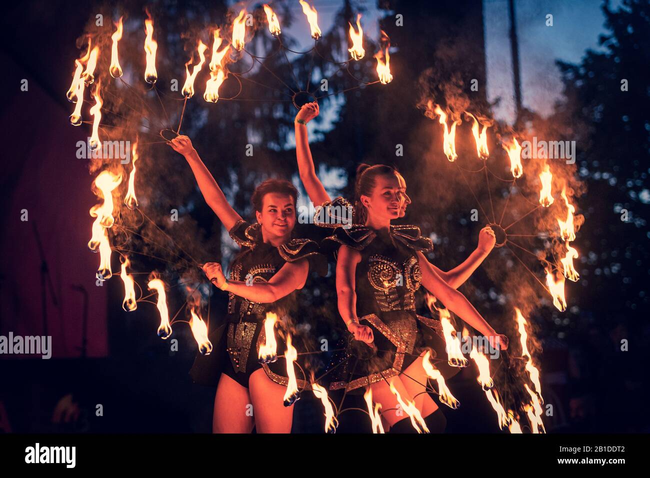 Performance of artists of the fire show in front of the public at the