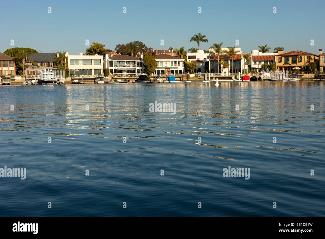 Mansion homes line the water in Newport Bay, Newport Beach, California, USA. Stock Photo