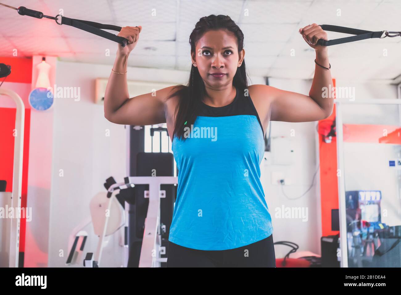 Young woman weight training at gym Stock Photo