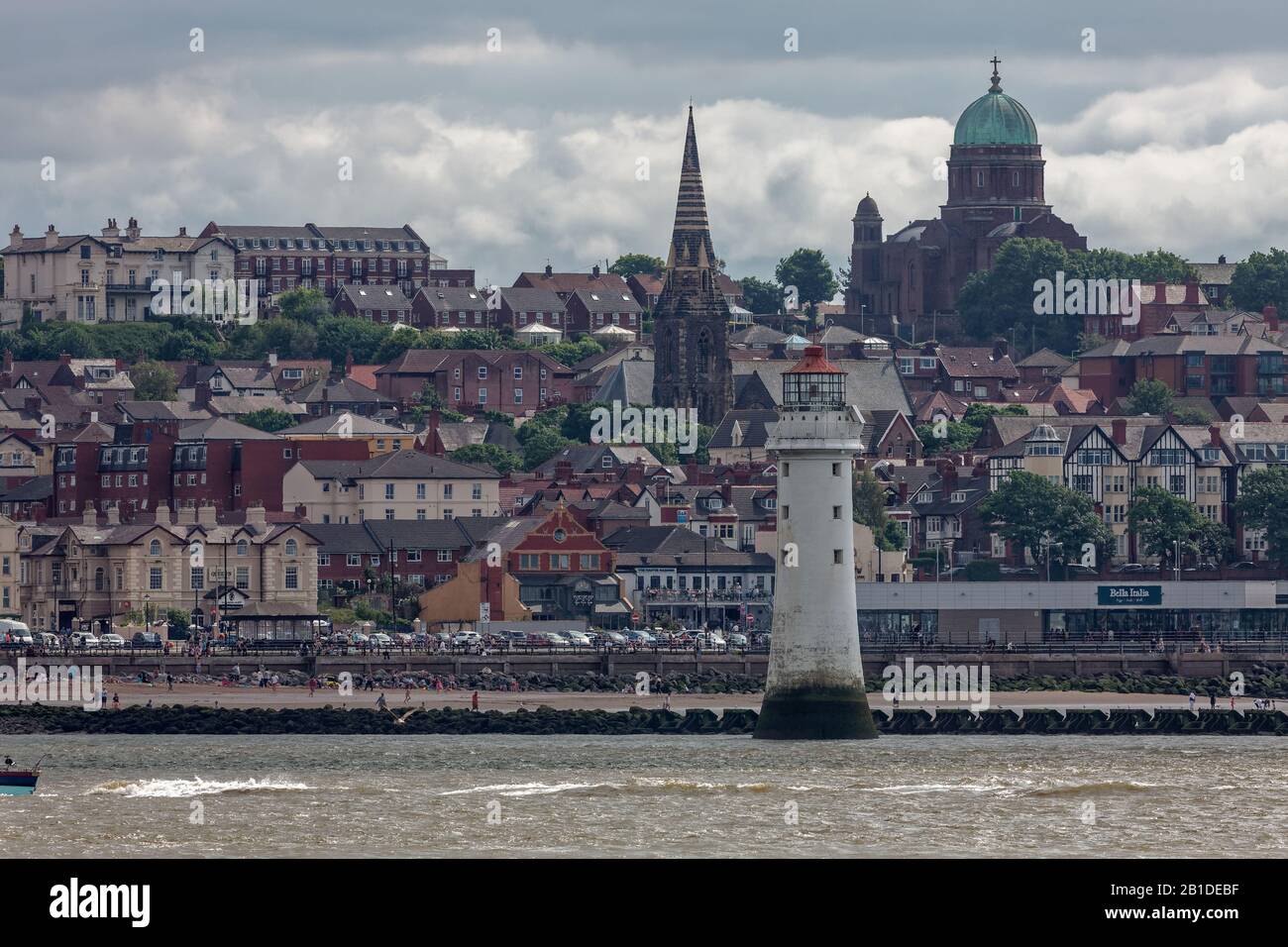 New Brighton viewed from offshore, including New Brighton Lighthouse, the Dome of Home catholic church and St James Church Stock Photo