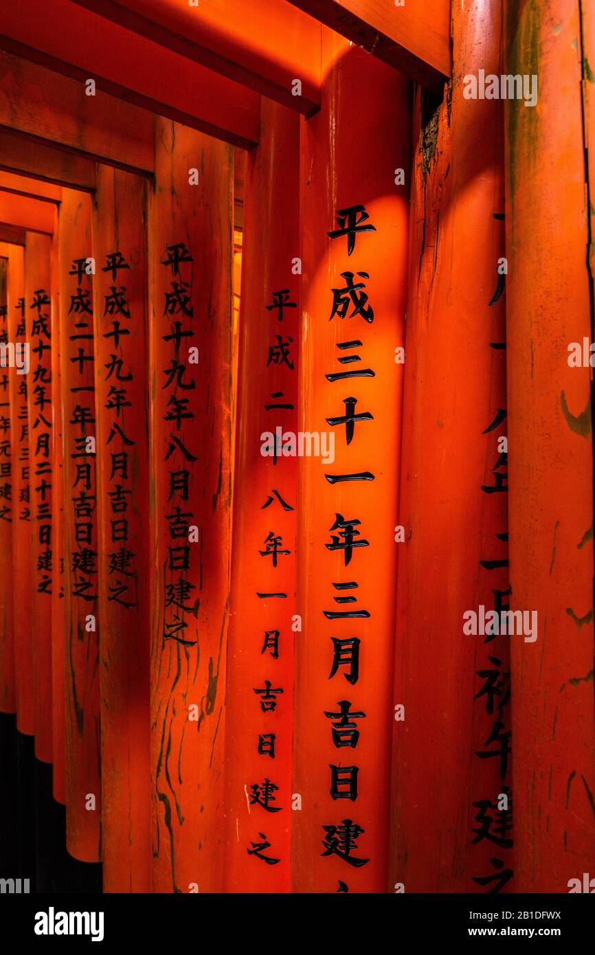 Detail of kanjii letters carved in the red torii gates at Fushimi Inari