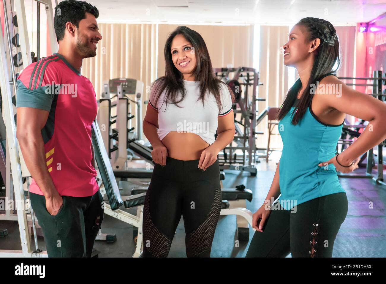 Group of friends relaxing and taking a break after working out at gym Stock Photo