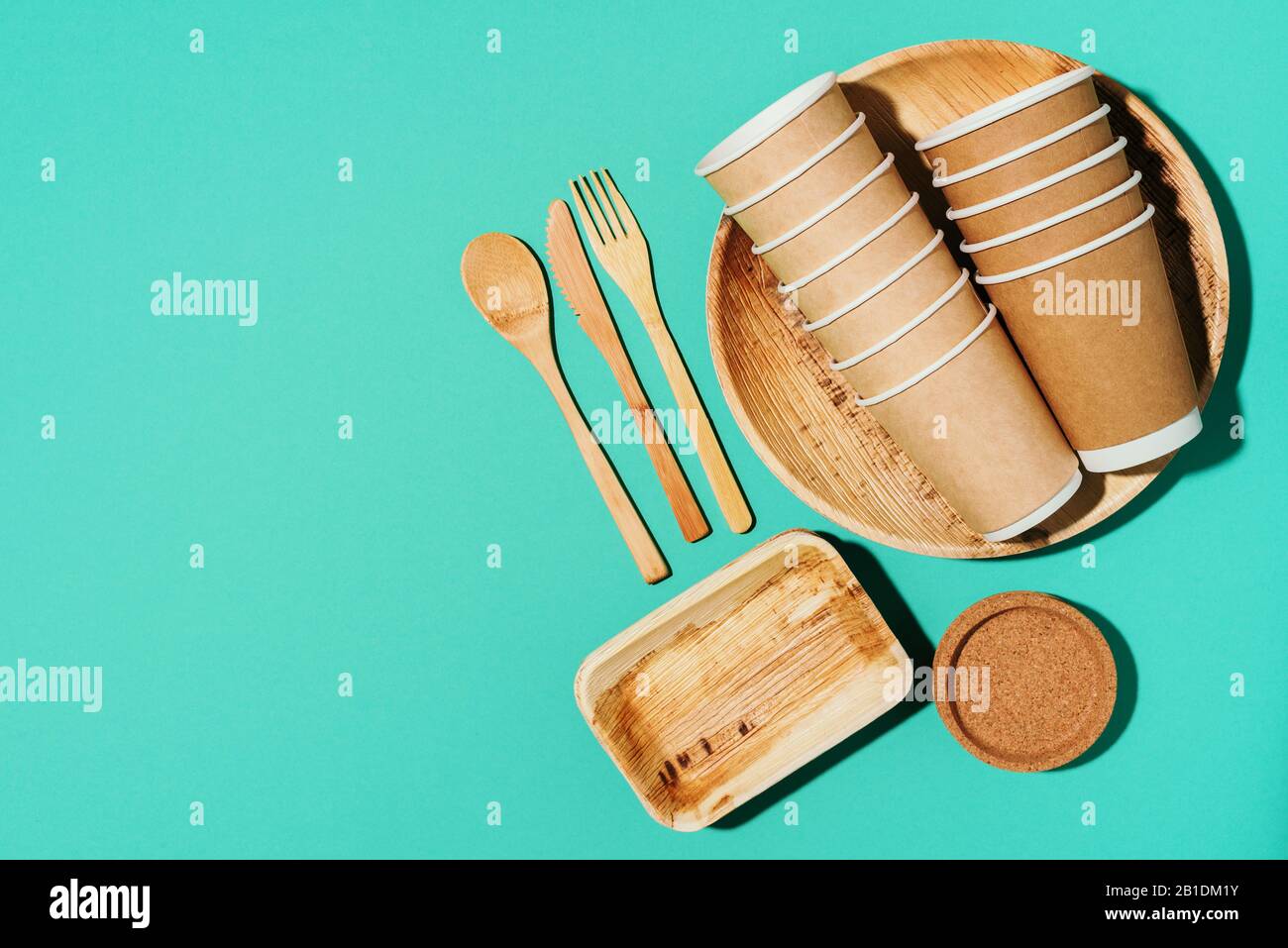 Disposable tableware from natural materials. Bamboo plates, wooden spoon,  fork, knife, craft paper cups on blue background. Eco-friendly sustainable  lifestyle. Eco-friendly disposable utensils Stock Photo - Alamy