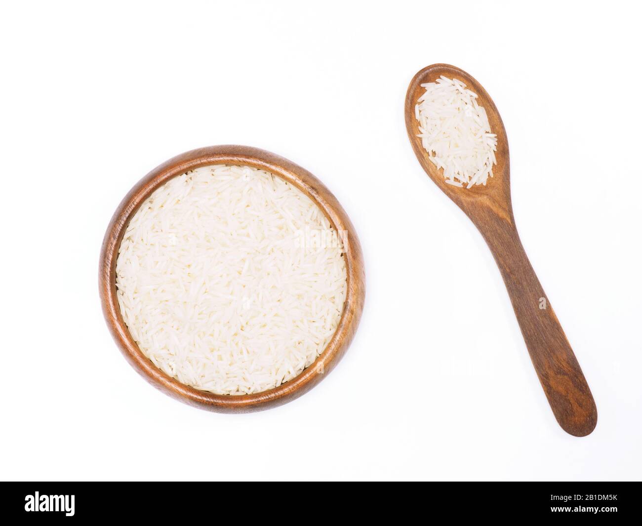 Indian long grain Basmati rice in brown wooden bowl and spoon isolated on white. Indian cuisine