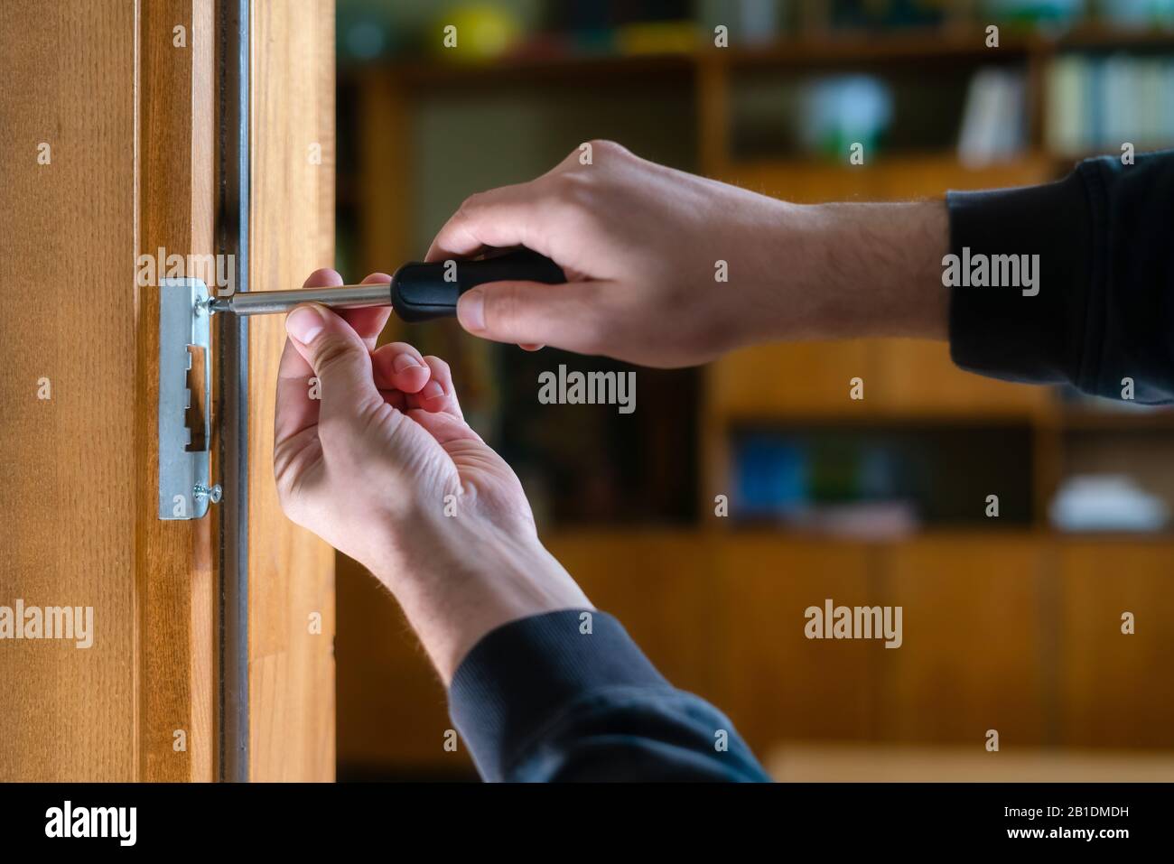 Carpenter repairing door lock. Installing a door handle. Handyman