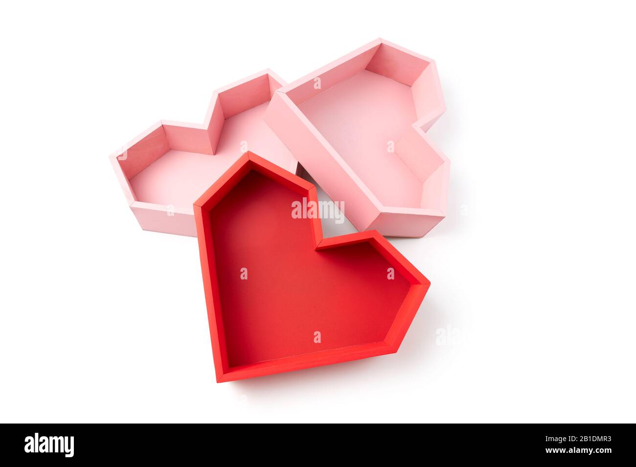 Empty boxes in the form of pink and red faceted hearts on a white background. Stock Photo