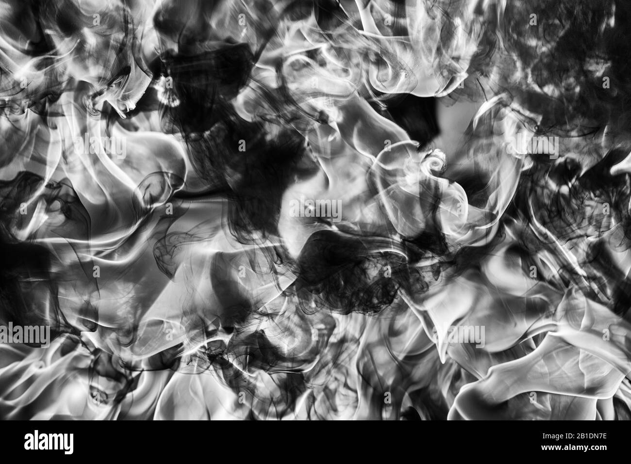 Abstract black smoke natural black smoke and white huge flame of strong fire. Dangerous firestorm abstract background. Motion blur from fire Stock Photo