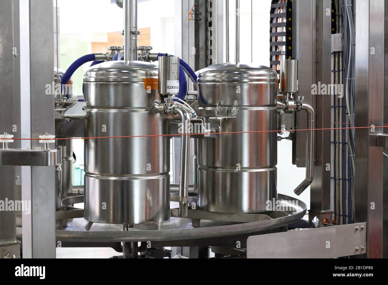 Stainless steel pipes in a food factory. Stainless steel fittings. Tubular heat exchangers. Food pumps. Technological equipment at the dairy factory. Stock Photo