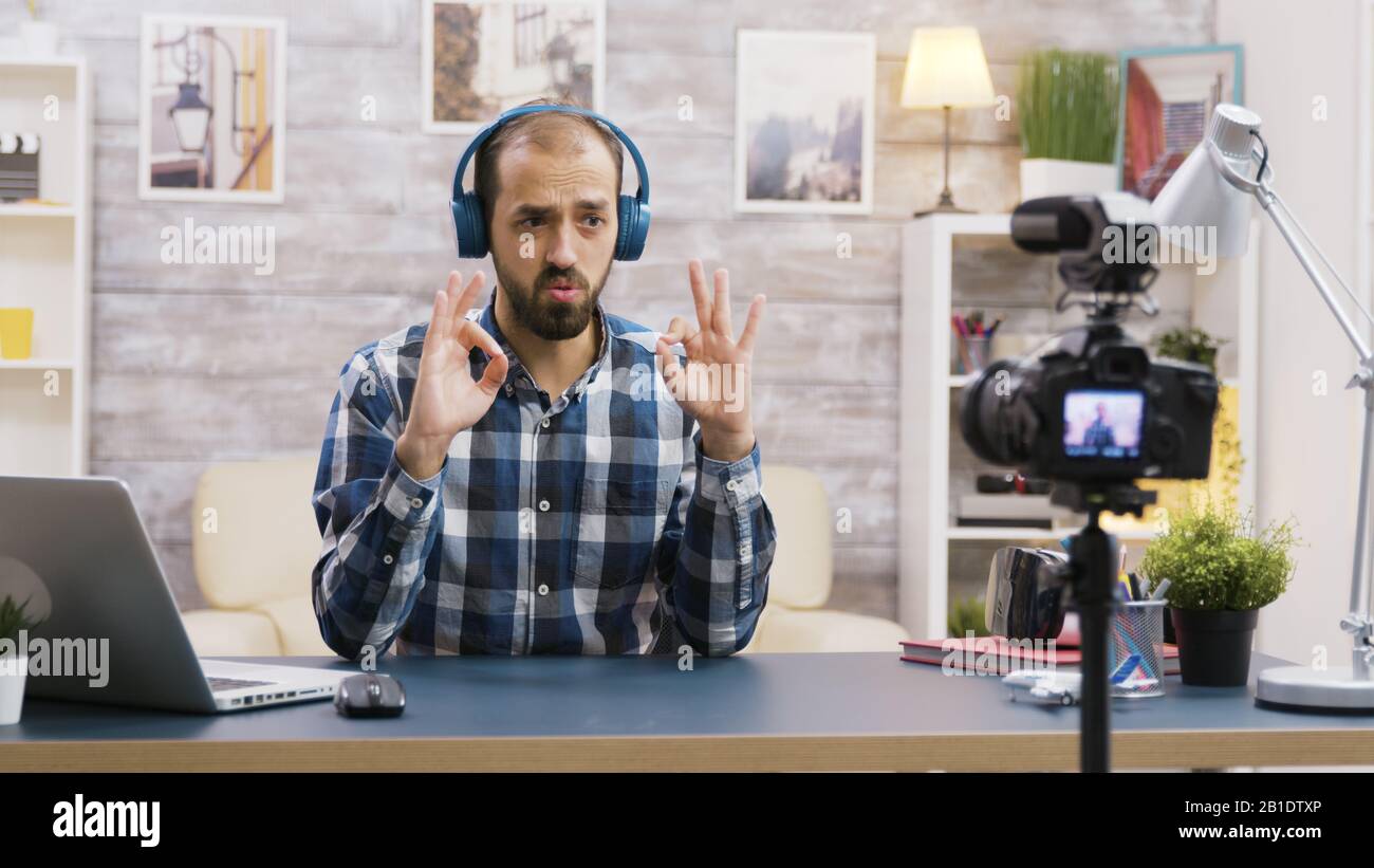 Famous influencer recording a review of a cool headphones. Creative content creator. Stock Photo