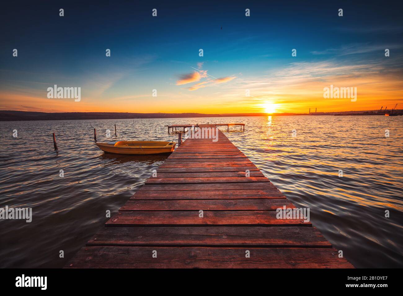 Small Dock and Boat at the lake, sunset shot Stock Photo - Alamy