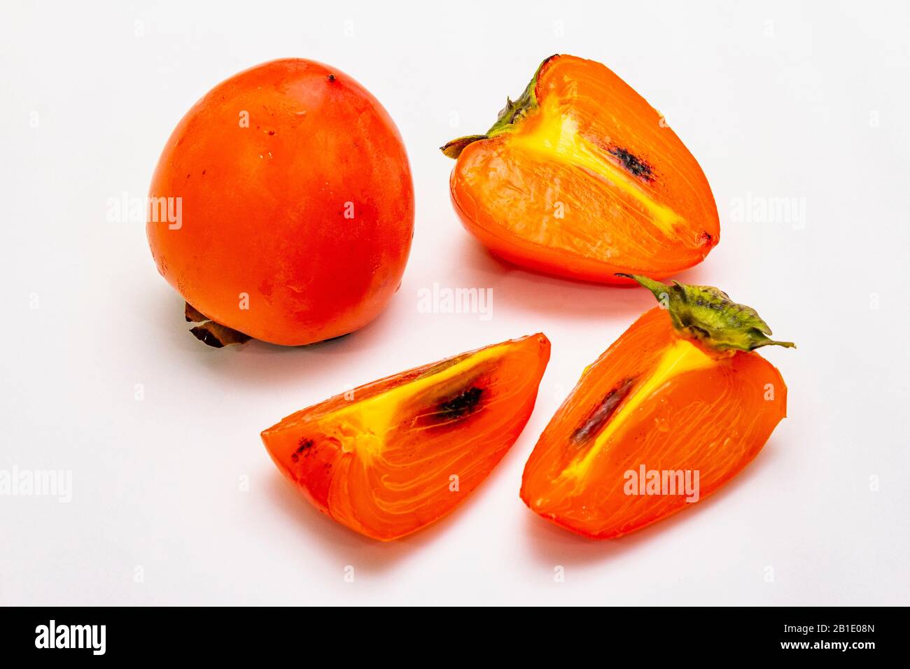 Ripe single persimmon. Fresh whole fruit, half sliced, seeds. Isolated ...