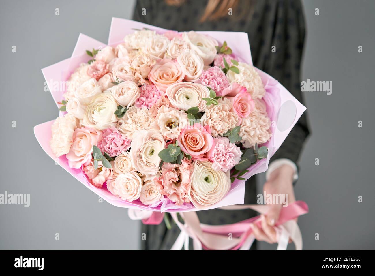 European floral shop. Beautiful bouquet of mixed flowers in womans