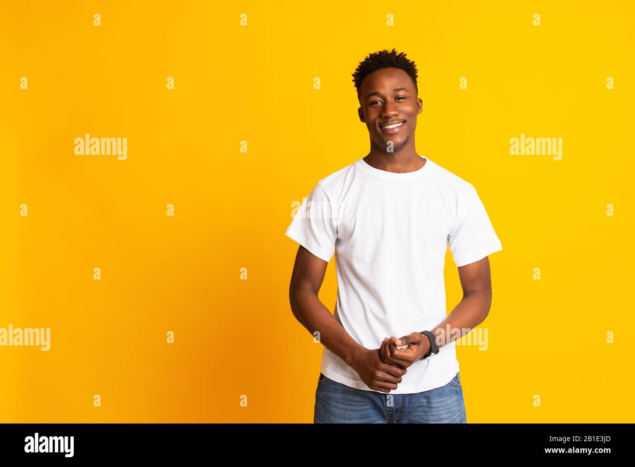Charming young african man in casual wear widely smiling Stock Photo