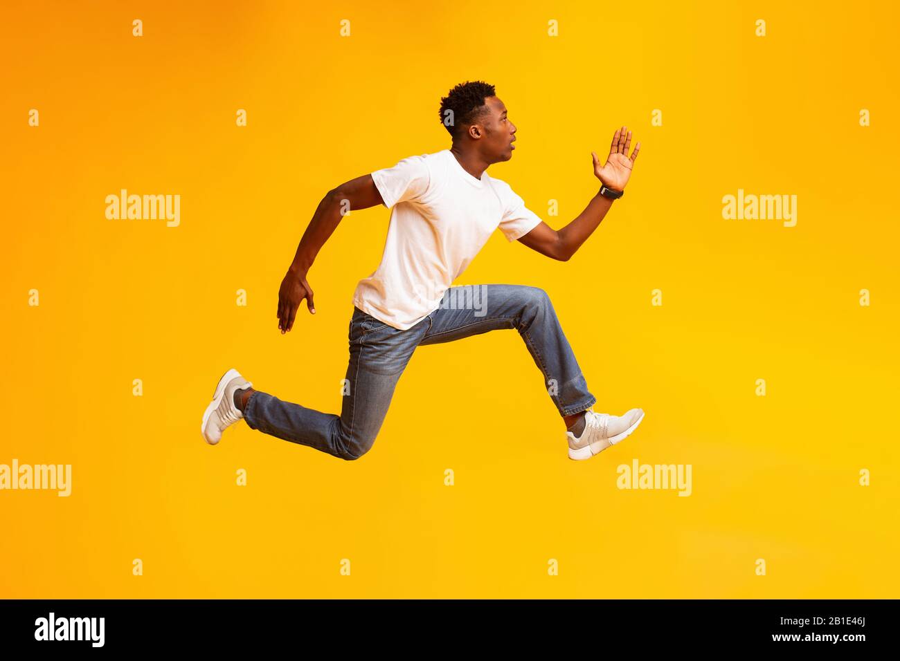 African guy jump, run fast, hurry up to sales or discounts Stock Photo